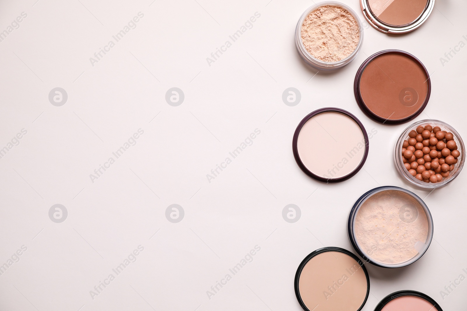 Photo of Different face powders on light background, flat lay. Space for text