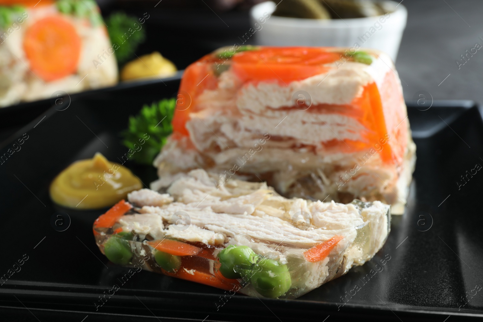 Photo of Delicious chicken aspic with vegetables on plate, closeup