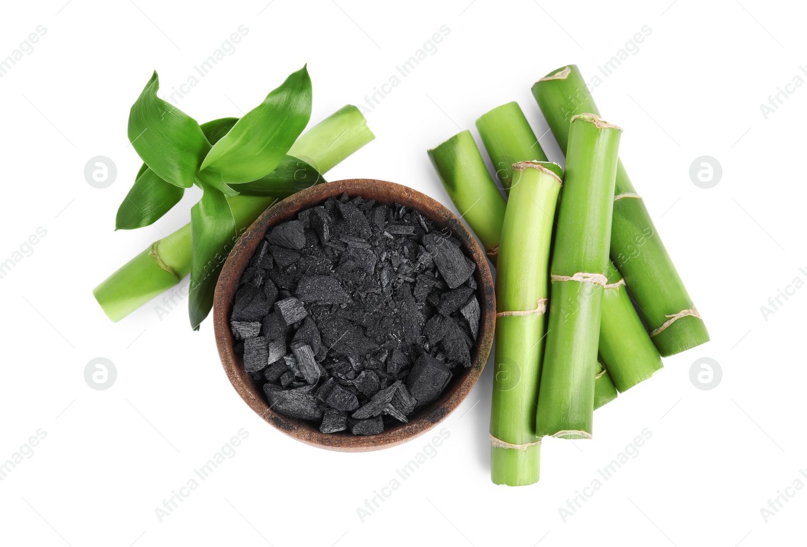 Photo of Fresh bamboo and charcoal on white background, top view
