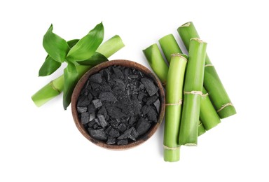 Photo of Fresh bamboo and charcoal on white background, top view