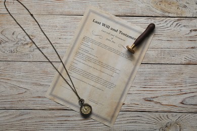 Photo of Last Will and Testament with wax stamp and pocket watch on wooden table, top view