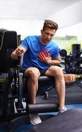 Photo of Young man having heart attack in gym