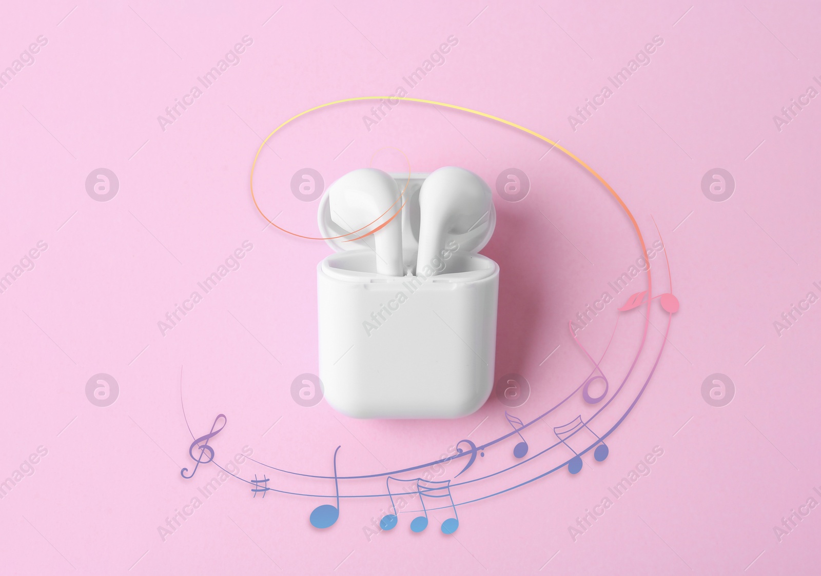 Image of Staff with music notes and treble clef flowing from white wireless earphones in charging case on pink background, top view