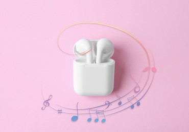 Image of Staff with music notes and treble clef flowing from white wireless earphones in charging case on pink background, top view