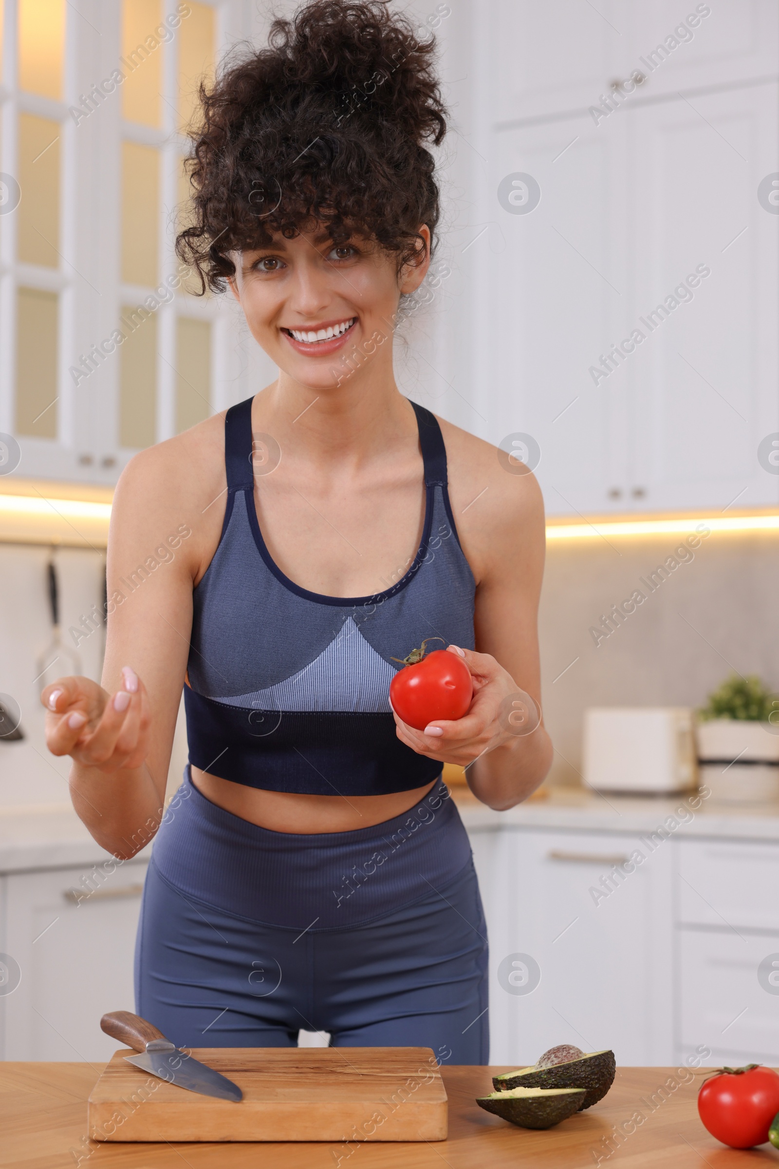 Photo of Smiling food blogger cooking in kitchen at home