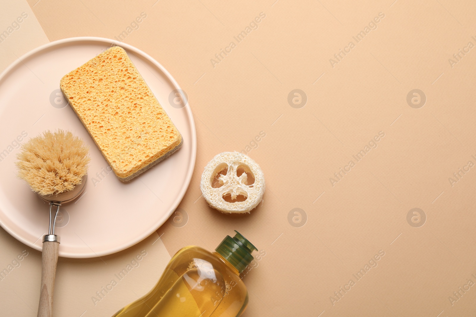 Photo of Flat lay composition with sponge and other bath supplies on beige background. Space for text