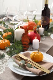 Photo of Beautiful autumn table setting. Plates, cutlery, glasses, pumpkins and floral decor