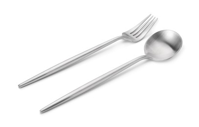 Photo of Shiny silver fork and spoon isolated on white. Luxury cutlery