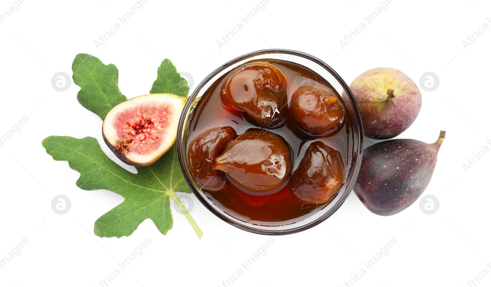 Photo of Bowl of tasty sweet jam, fresh figs and green leaf isolated on white, top view