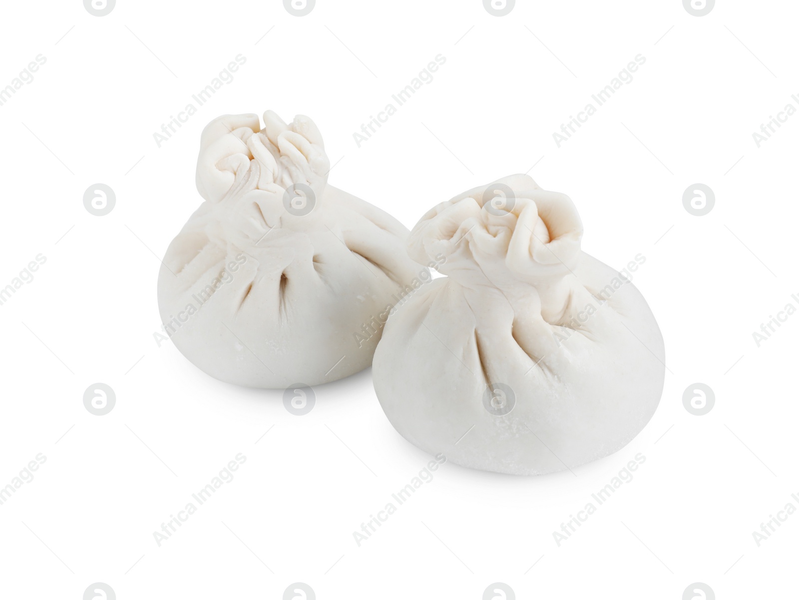 Photo of Uncooked khinkali (dumplings) isolated on white. Georgian cuisine