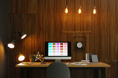 Photo of Modern designer's workplace with computer in office