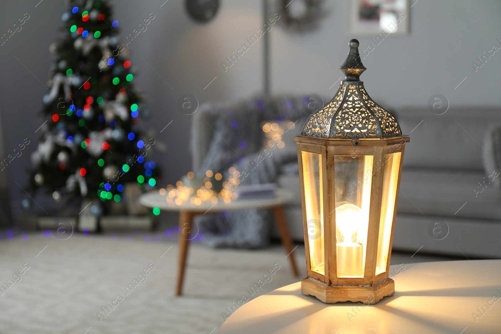 Photo of Beautiful decorative lantern and Christmas tree in room