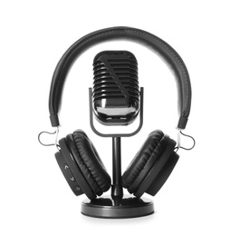 Photo of Retro microphone and headphones on white background