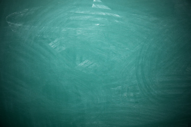 Photo of Dirty green chalkboard as background. Space for text