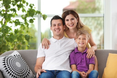Photo of Happy family with cute child at home