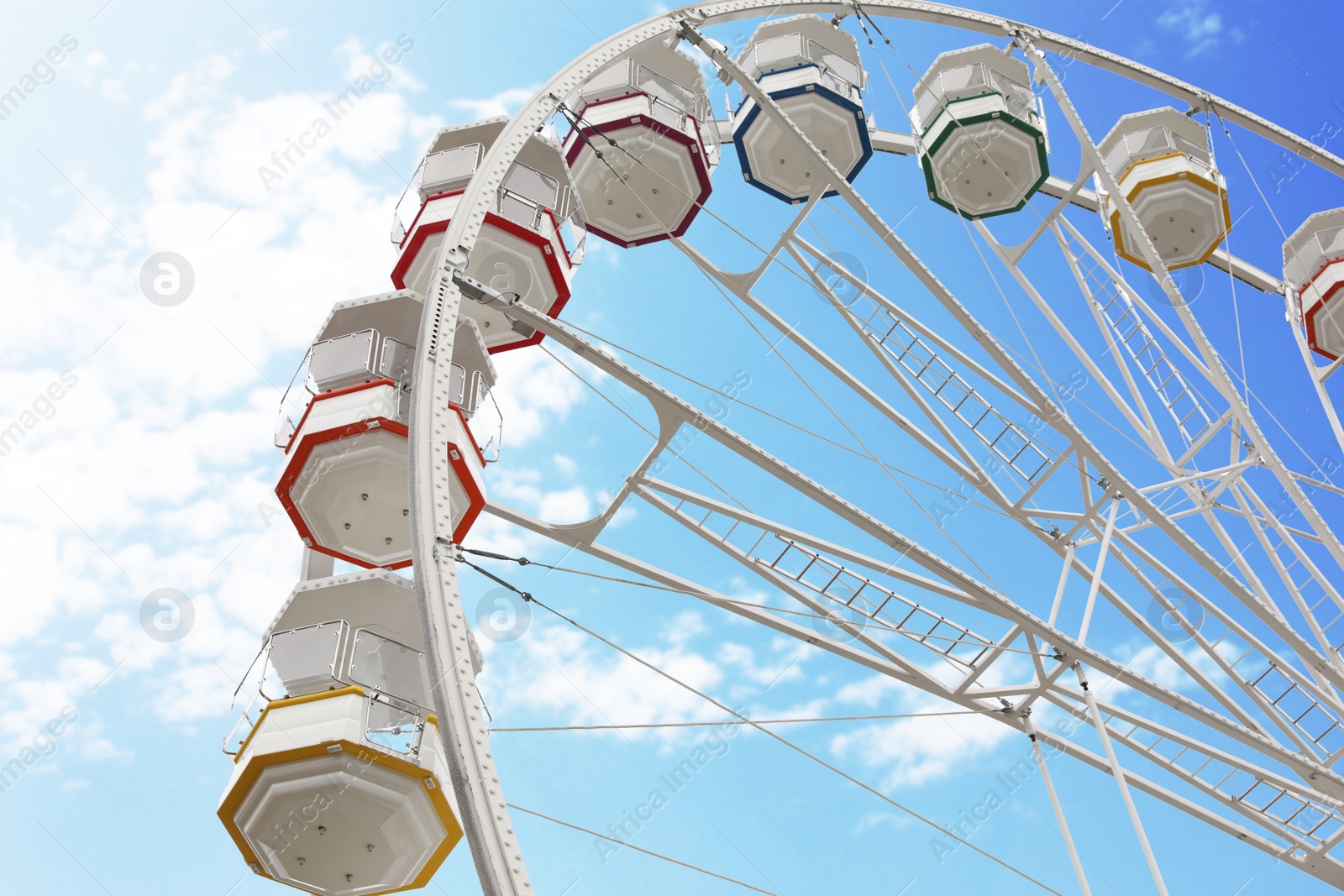 Photo of Large white observation wheel against sky, low angle view