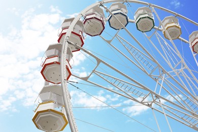 Large white observation wheel against sky, low angle view