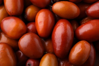 Photo of Heap of ripe red dates as background, closeup