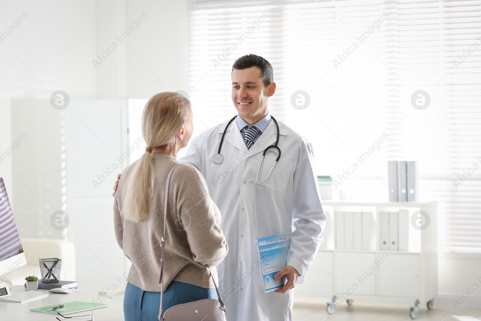 Photo of Doctor consulting patient in his office at hospital