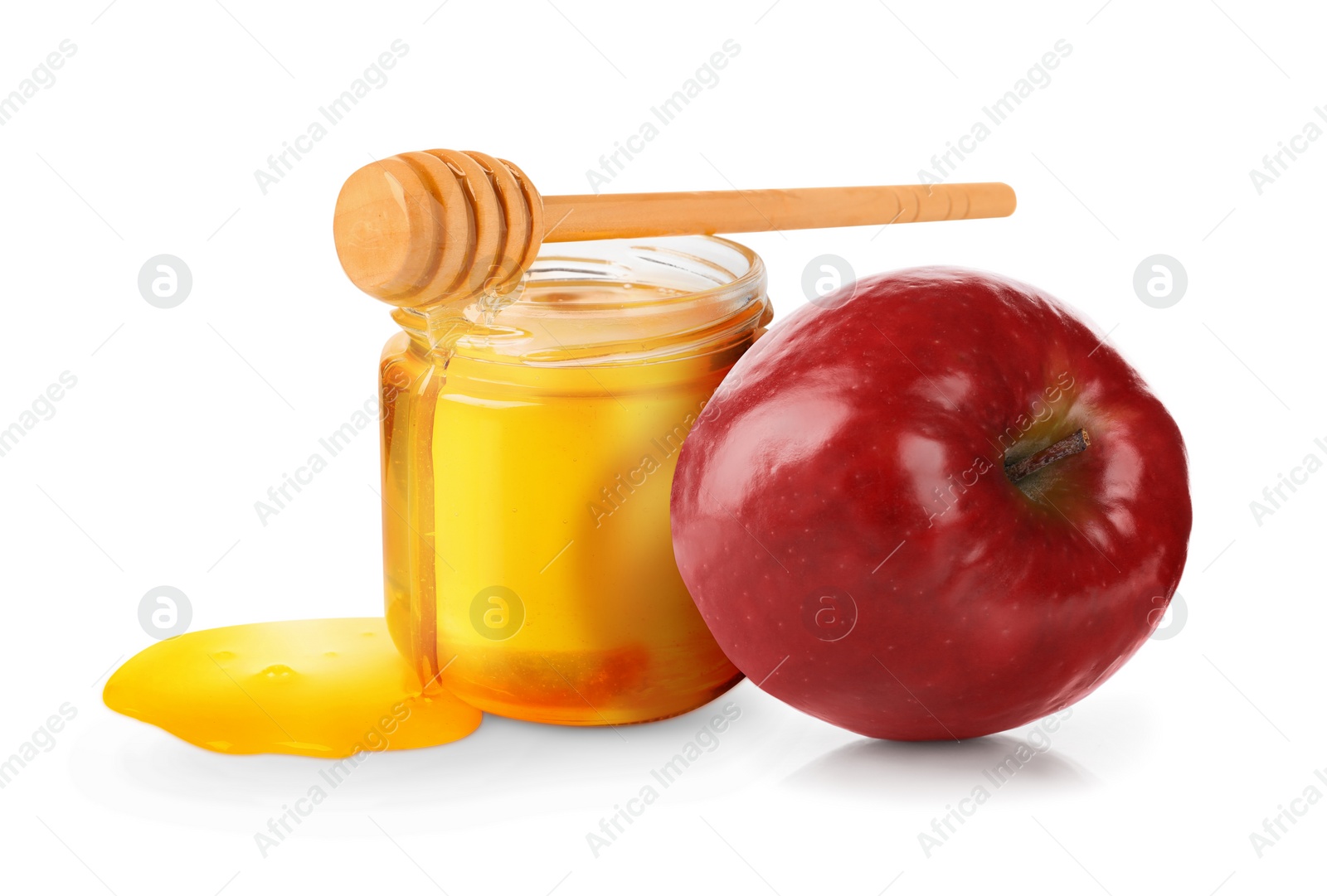 Image of Honey in glass jar, apple and dipper isolated on white