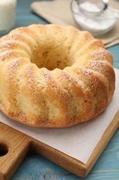 Photo of Delicious freshly baked sponge cake on light blue table, closeup