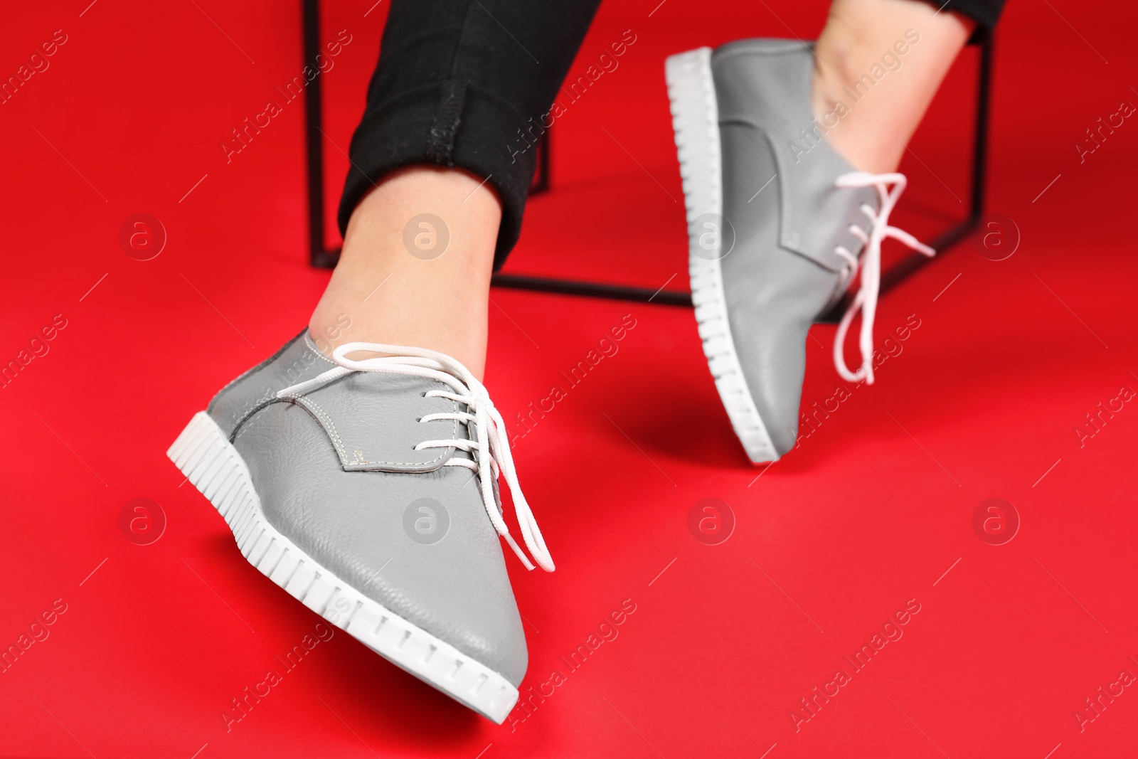 Photo of Woman in stylish shoes on color background