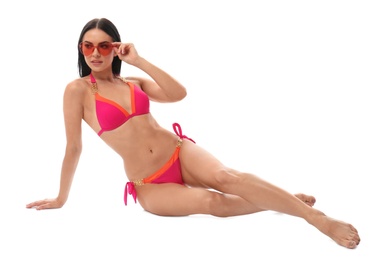 Photo of Beautiful young woman in stylish bikini with sunglasses on white background