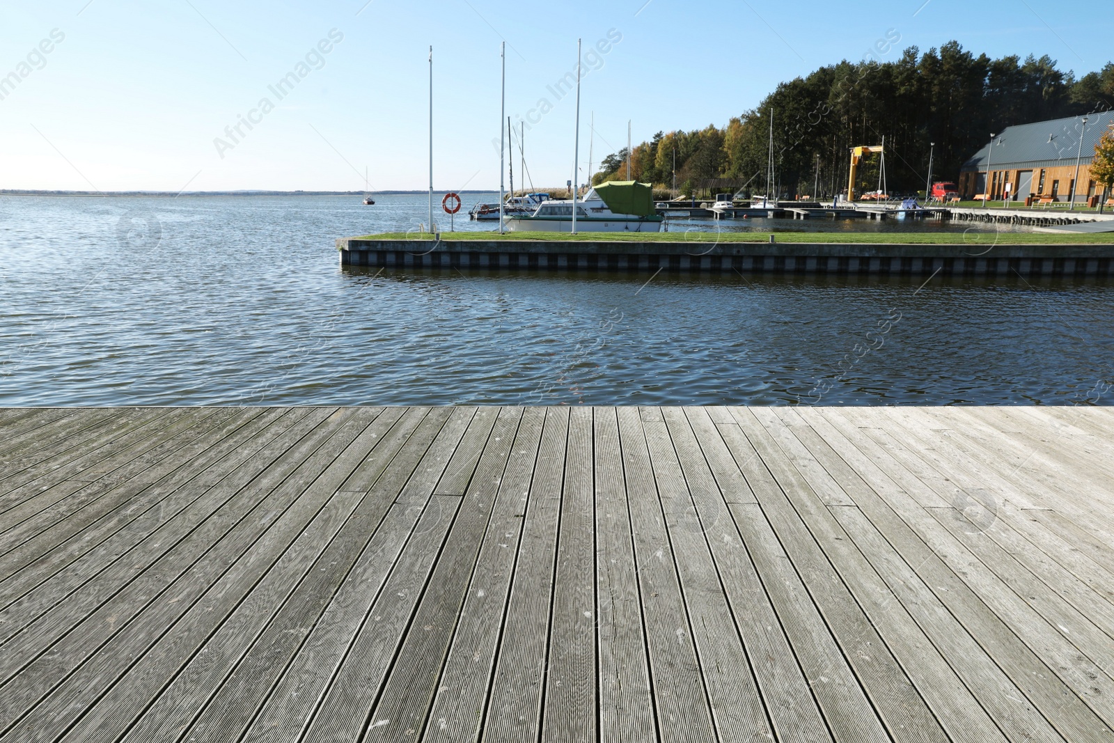 Photo of Beautiful view of wooden terrace near river on sunny day