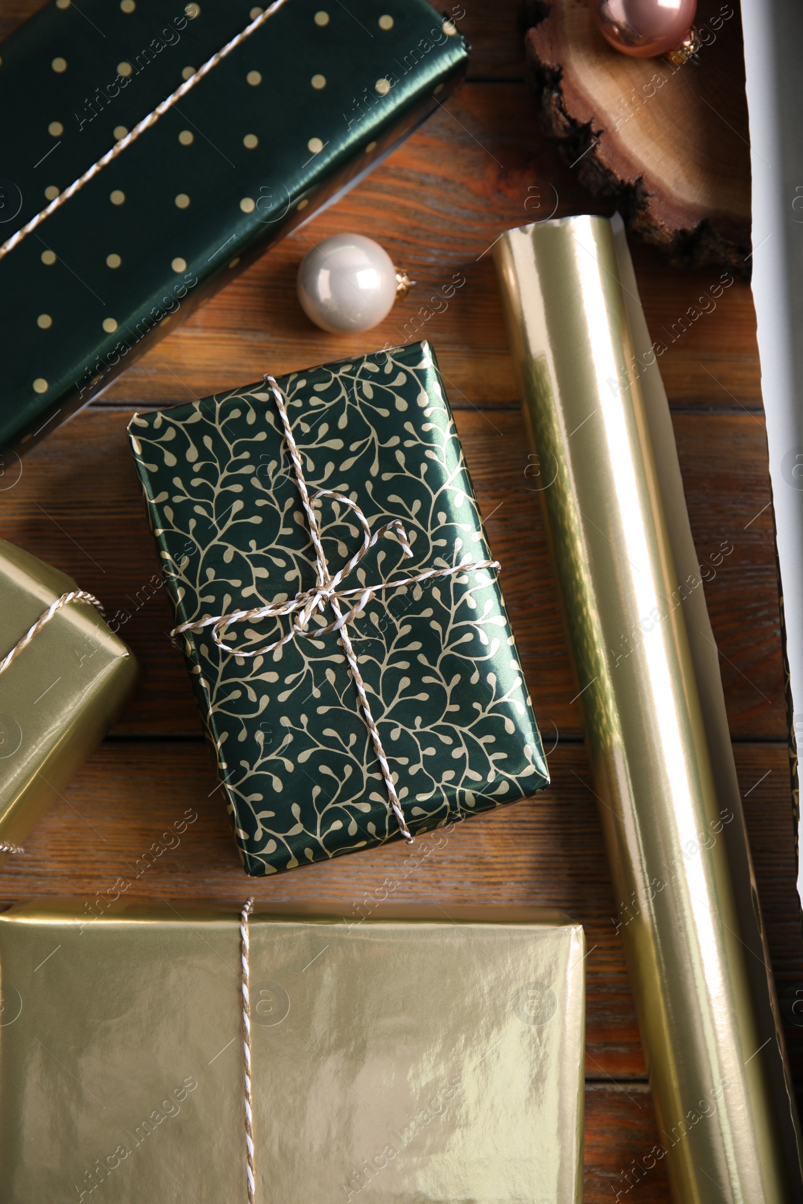 Photo of Flat lay composition with beautifully wrapped gift boxes on wooden table