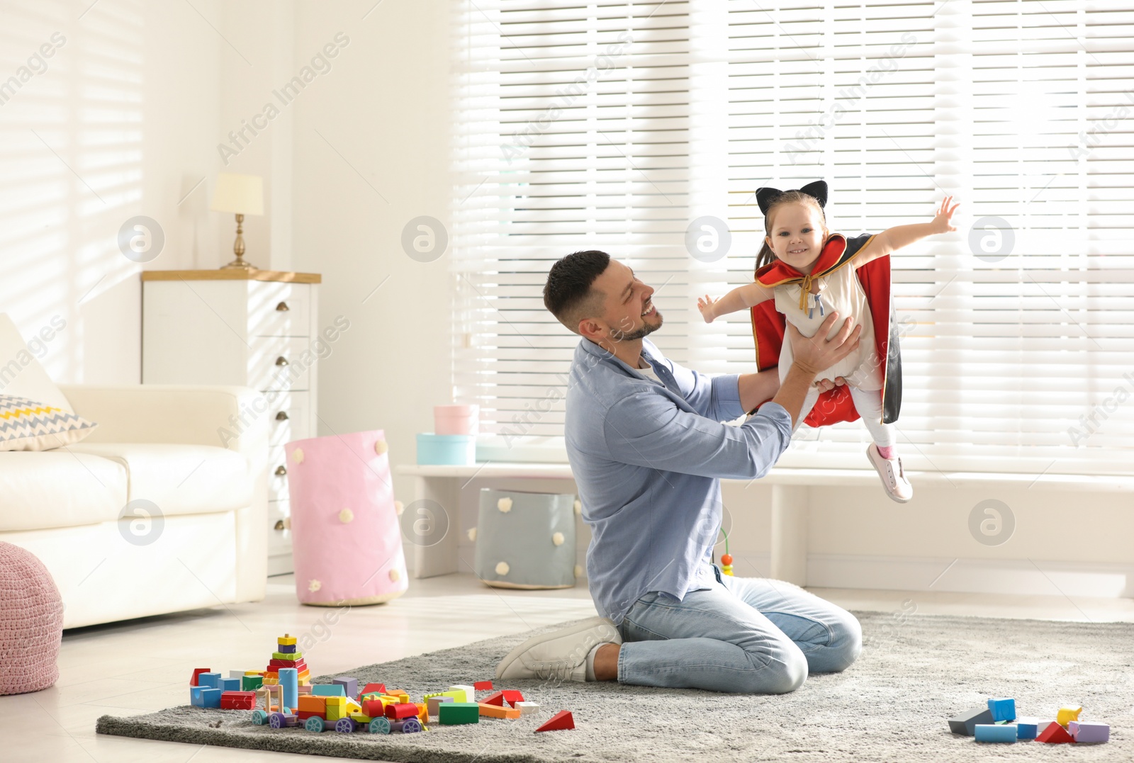 Photo of Father playing with his child at home