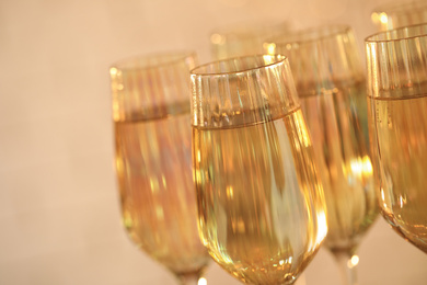 Photo of Glasses of champagne on blurred background, closeup