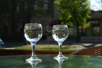 Photo of Two glasses of water at table in cafe, after coffee refreshing drink