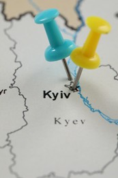MYKOLAIV, UKRAINE - NOVEMBER 09, 2020: Kyiv city marked with push pins on contour map of Ukraine, closeup
