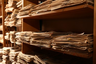 Collection of old newspapers on shelves in library