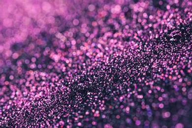 Photo of Pink glitter with bokeh effect on dark background