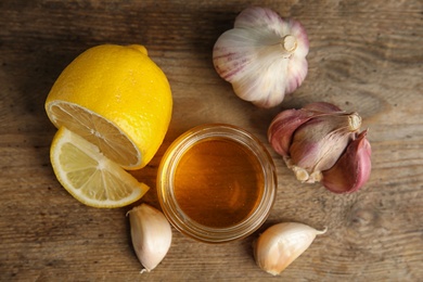 Photo of Flat lay composition with cold remedies on wooden table. Sore throat treatment