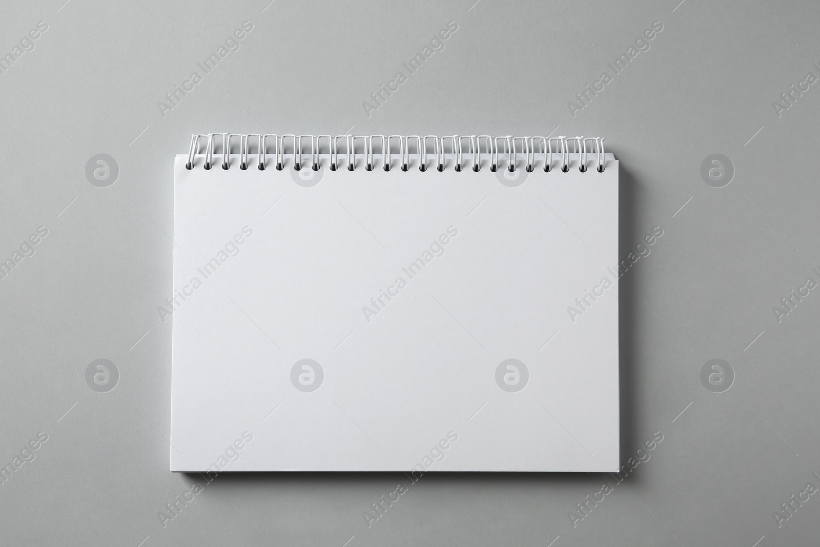 Photo of Blank notebook on grey background, top view. Mockup for design