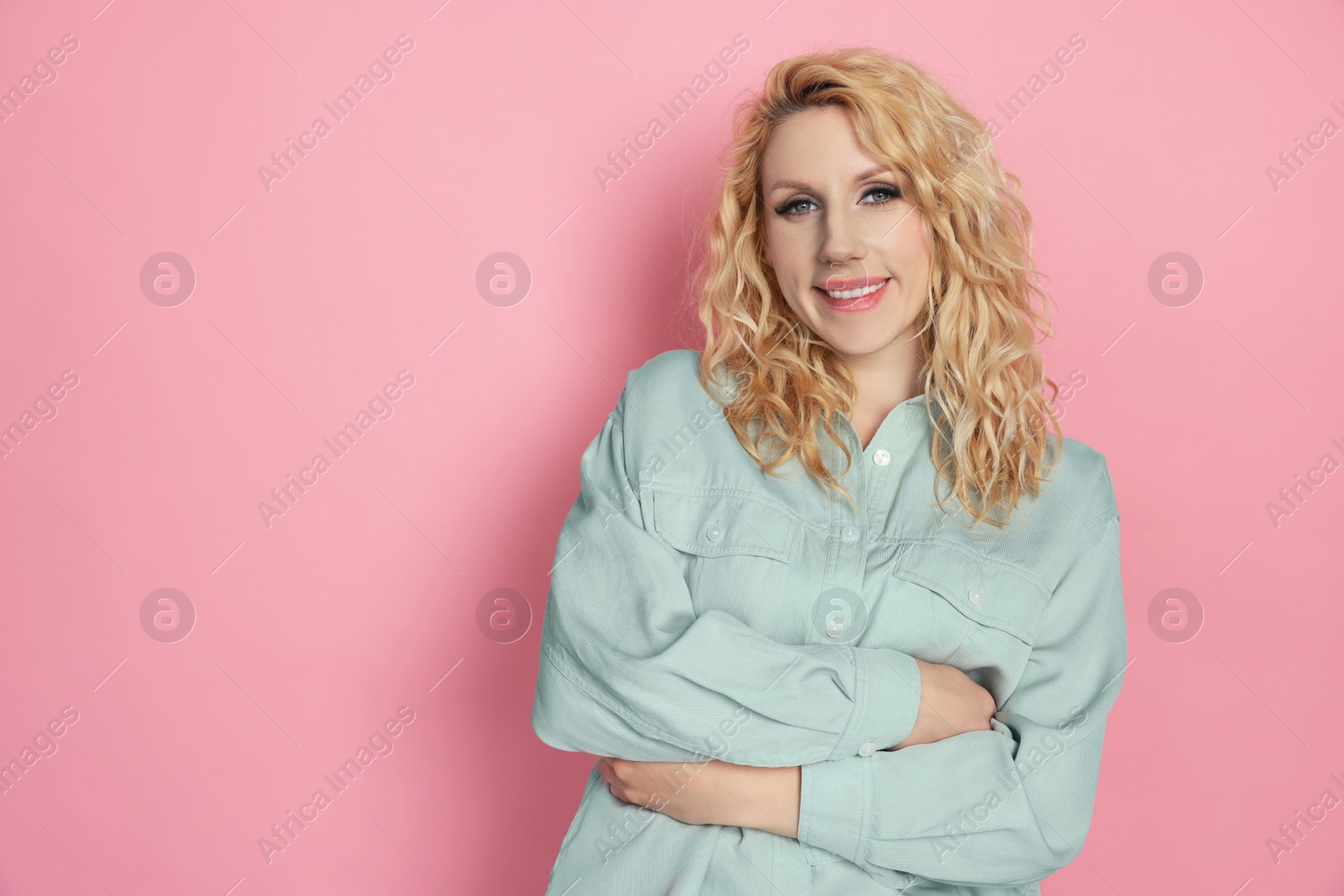 Photo of Portrait of beautiful young woman on pink background. Space for text