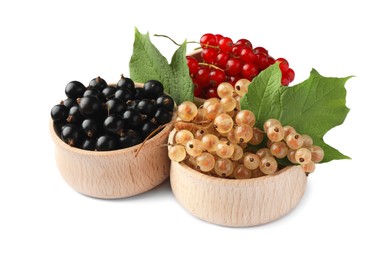Photo of Fresh red, white and black currants with green leaves in bowls isolated on white
