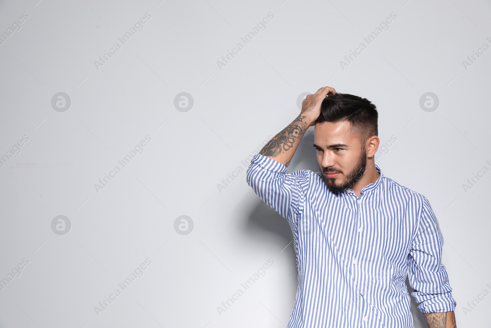 Photo of Portrait of handsome young man against light background. Space for text