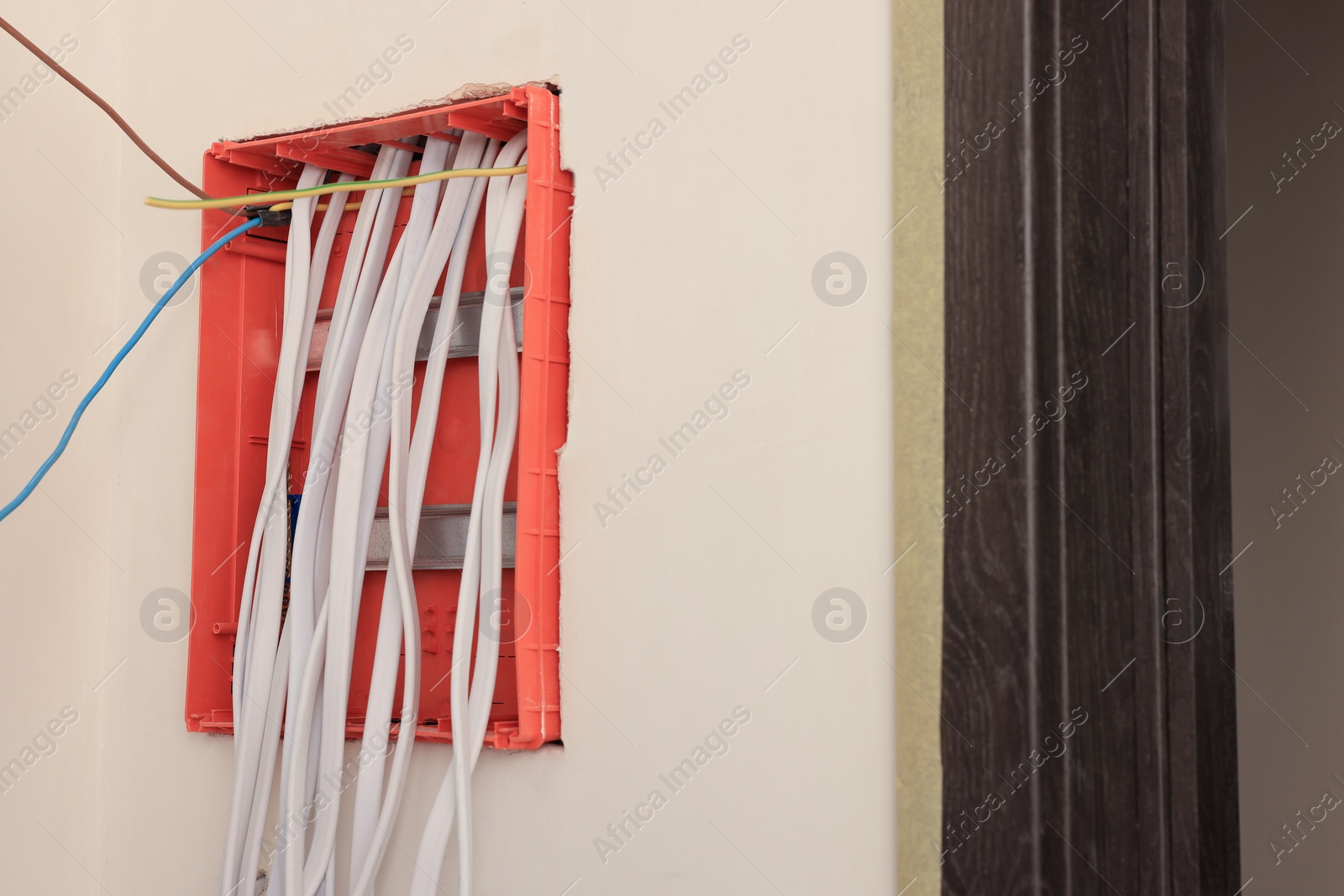 Photo of Switchboard with wires on wall indoors, space for text