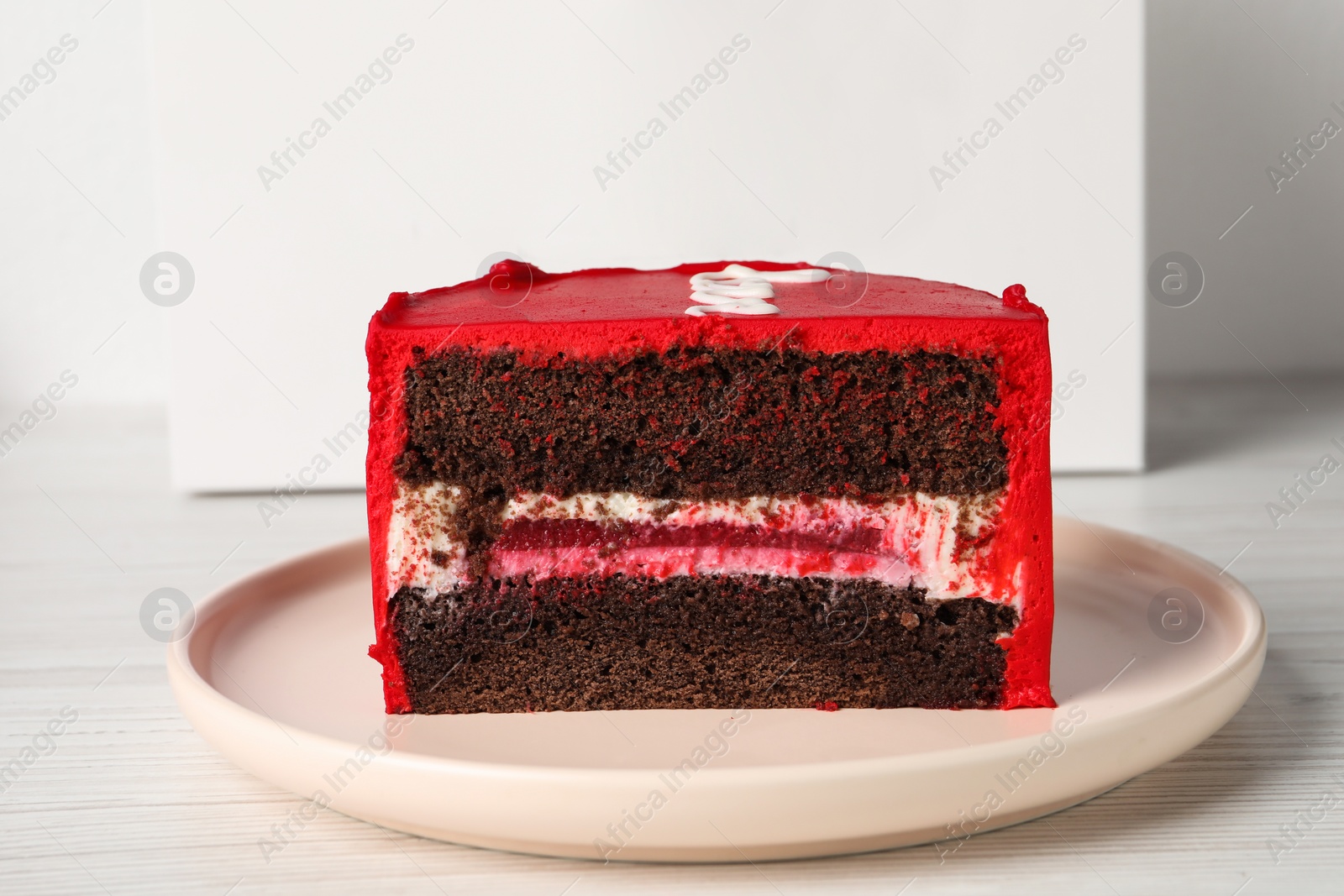 Photo of Cut bento cake on white table, closeup