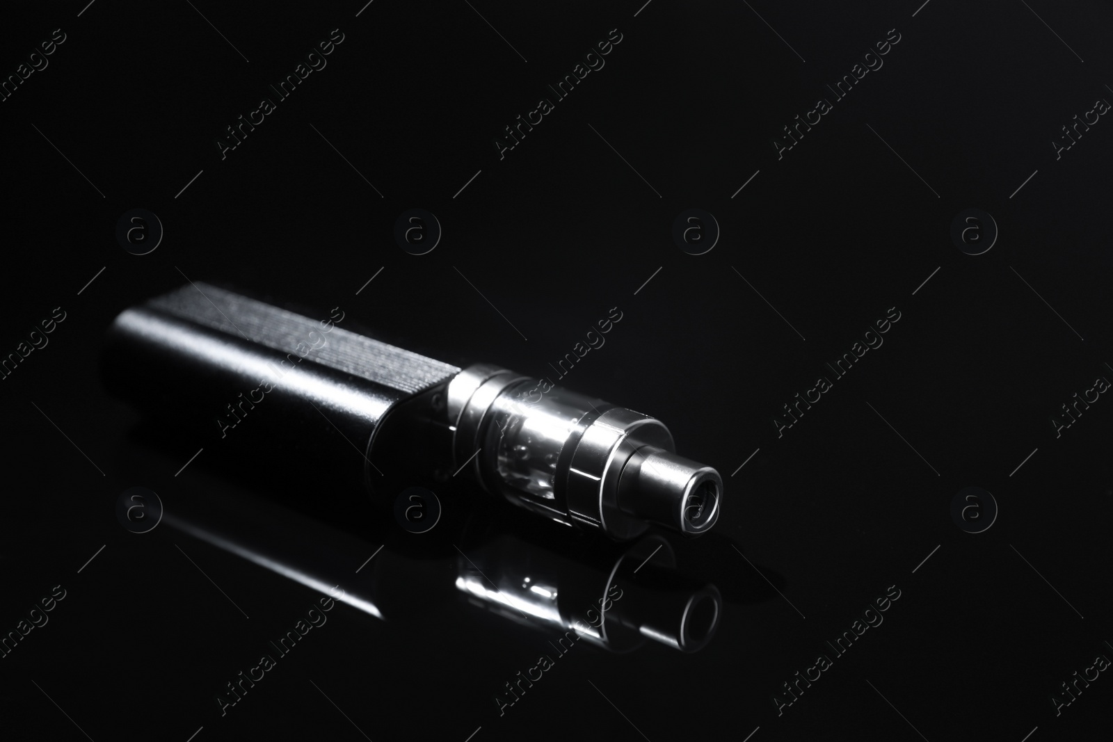 Photo of Electronic cigarette on black background, space for text