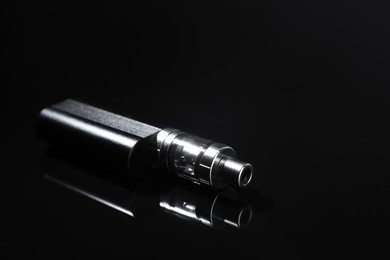 Photo of Electronic cigarette on black background, space for text