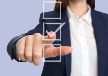 Image of Woman pointing at check mark in box on virtual screen, closeup