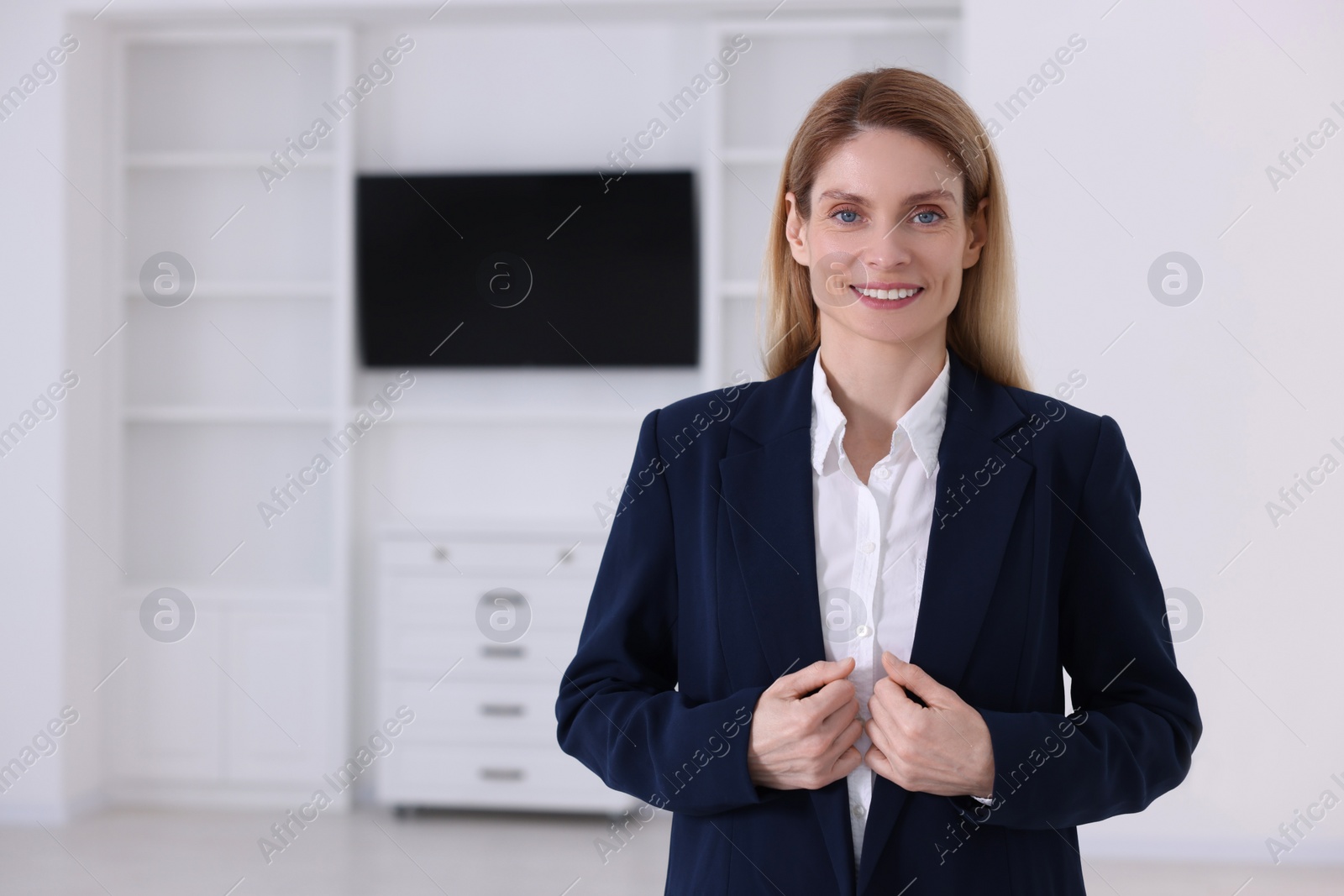 Photo of Happy real estate agent in new apartment. Space for text