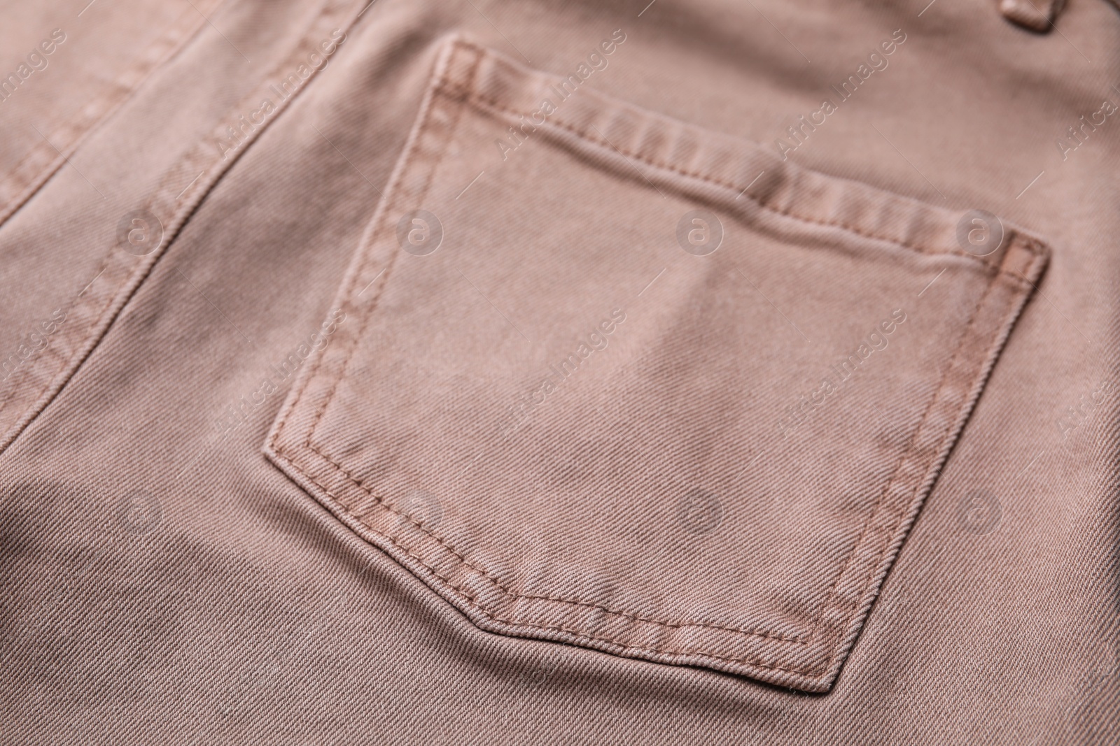 Photo of Beige jeans with pockets as background, closeup