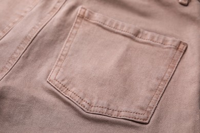 Beige jeans with pockets as background, closeup