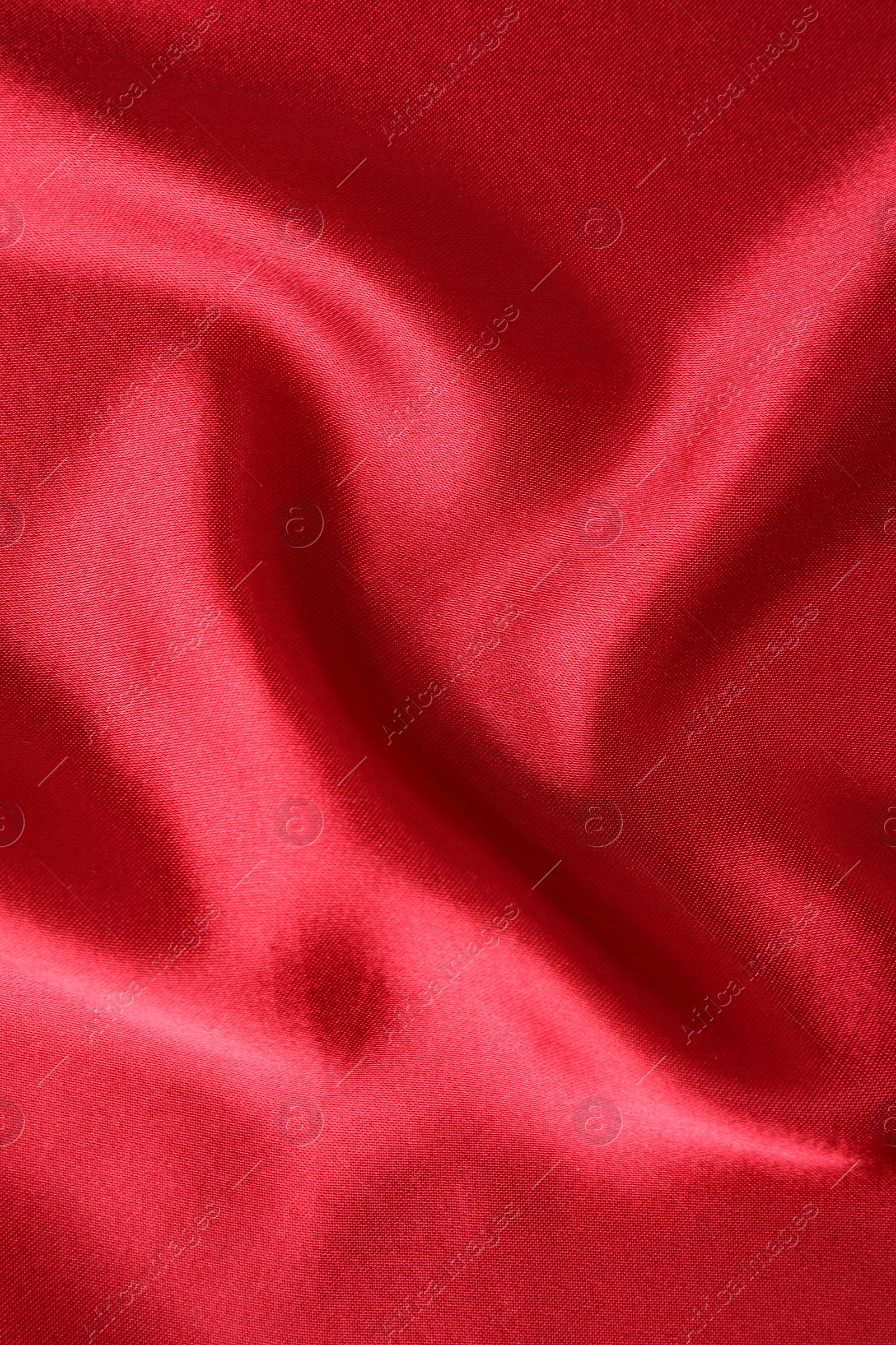 Photo of Texture of beautiful red silk fabric as background, closeup