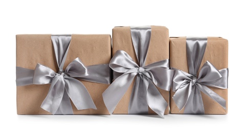 Photo of Beautifully wrapped gift boxes on white background